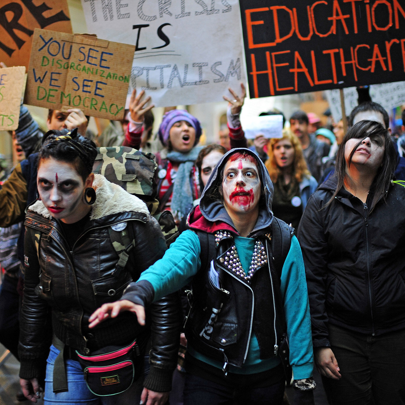 "Occupy Wall Street" demonstrators stage a march past the New York Stock Exchange dressed as corporate zombies during a protest on Wall Street in New York, October 3, 2011. The protestors, speaking out against corporate greed and other issues carried on their occupation of Zuccotti Park, near the New York Stock Exchange, despite mass arrests over the weekend.   AFP PHOTO/Emmanuel Dunand